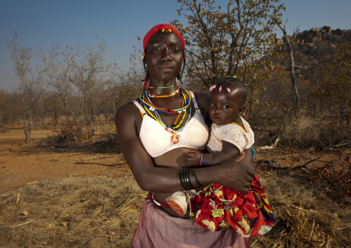 Mudimba Woman Wearing A Bra Holding Her Baby, Village Of Combelo, Angola