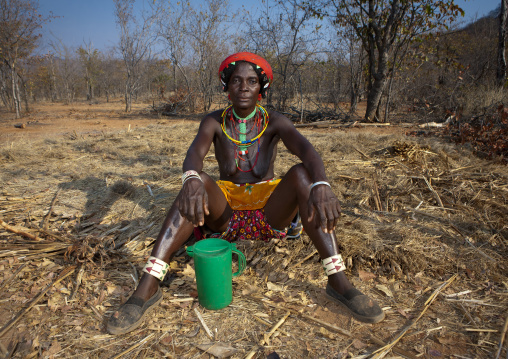 Mudimba Woman With Naked Breast Sitting On The Ground, Village Of Combelo, Angola