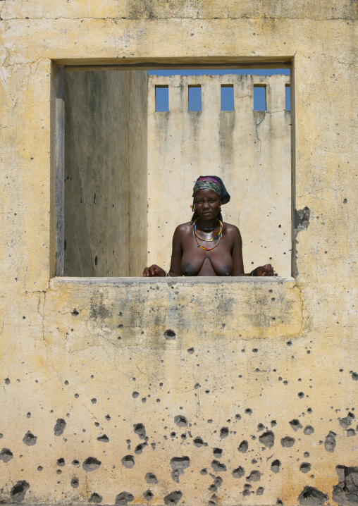 Woman Behind A Wall Riddled With Bullet Impacts, Village Of Chitado, Angola