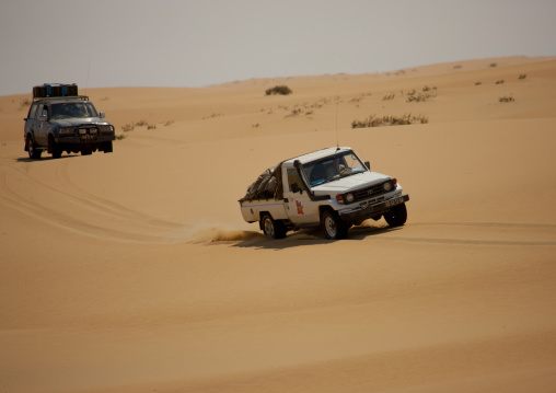 Tourists Doing A Safari Tour In Four Wheel Drives In The Namib Desert, Iona National Park, Angola