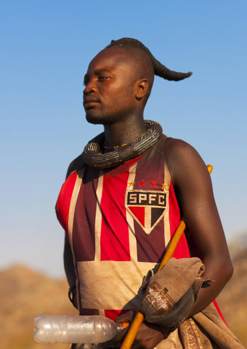 Muhimba tribe man with a São Paulo Futebol Clube football shirt,  Iona Village, Angola