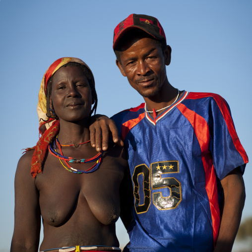 Mucawana Man Dressed In A Western Way With A Topless Mucawana Woman, Village Of Oncocua, Angola