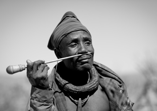 Muhimba Man Snuffing Tobacco, Village Of Elola, Angola