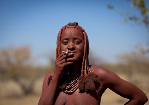 Muhimba Woman Smoking A Cigaret, Village Of Elola, Angola
