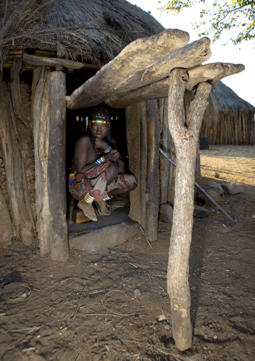 Mucawana Girl Crouching In The Engtrance Of Her Hut, Village Of Mahine, Angola