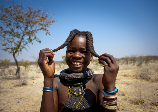 Himba Girl Called Kamundomba Holding Her Two Plaits, Village Of Habu Haru, Angola