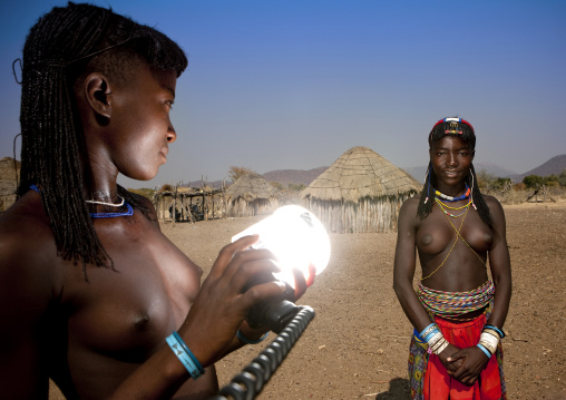 Mucawana Girl Lighting Her Friend With A Flash Light, Village Of Soba, Angola