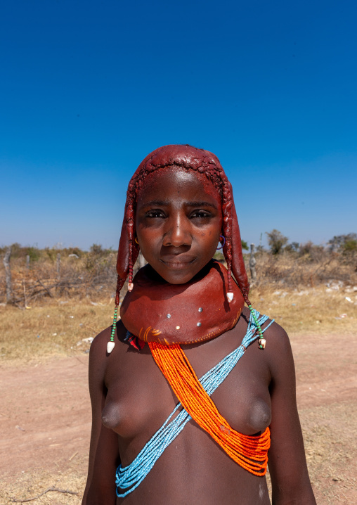Portrait of a Mumuhuila tribe teenage girl portrait wearing a huge necklace, Huila Province, Chibia, Angola
