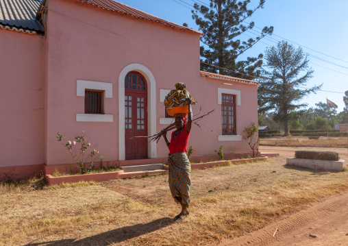 Angolan woman in front of an old portuguese colonial house, Huila Province, Lubango, Angola