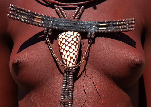 Himba tribe woman breast decorated with a shell, Cunene Province, Oncocua, Angola