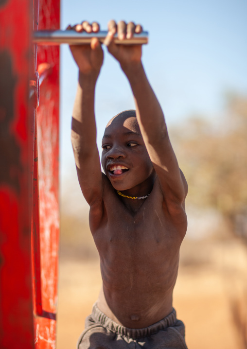 Muhacaona tribe boy pumping water in a well, Cunene Province, Oncocua, Angola