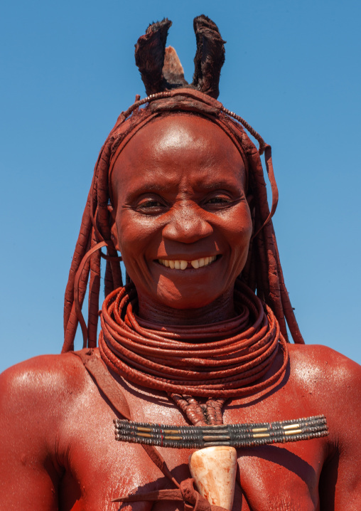 Portrait of a smiling Himba tribe woman covered with otjize, Cunene Province, Oncocua, Angola