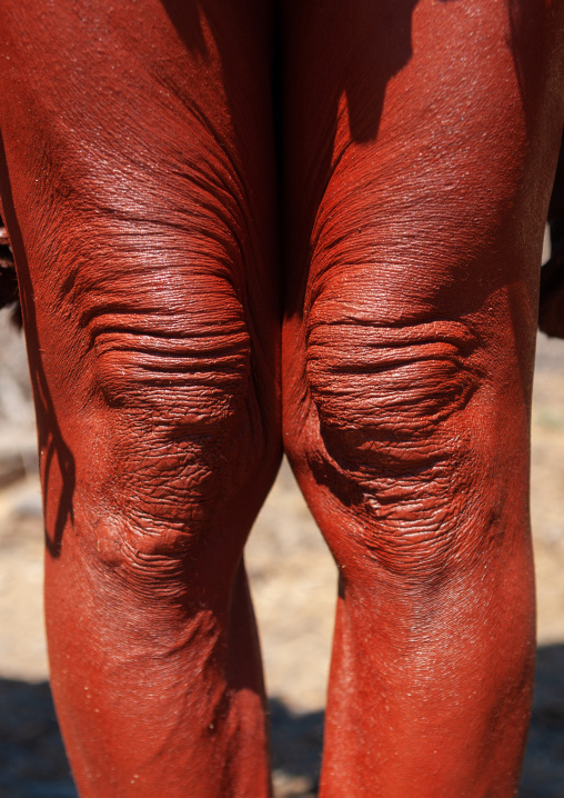 Himba tribe woman legs cvered with otjize, Cunene Province, Oncocua, Angola