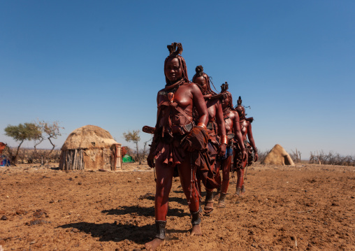 Himba tribe women walking in line, Cunene Province, Oncocua, Angola