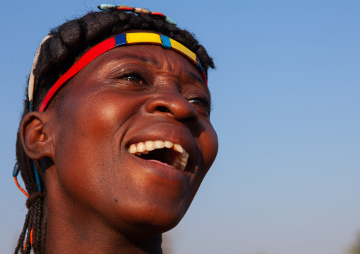 Portrait of a laughing Muhacaona  tribe woman, Cunene Province, Oncocua, Angola