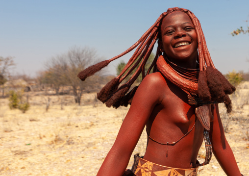 Portrait of a smiling Himba tribe woman covered with otjize, Cunene Province, Oncocua, Angola