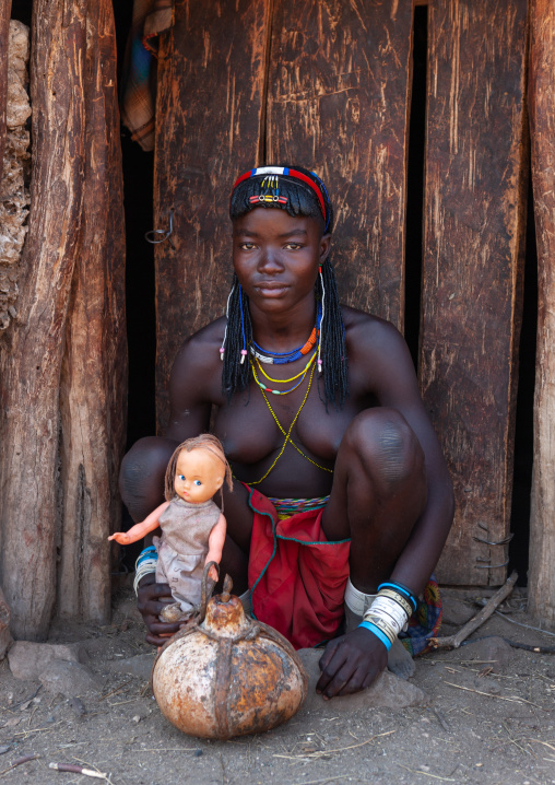 Muhacaona tribe woman with a western doll, Cunene Province, Oncocua, Angola