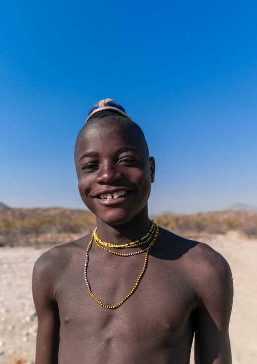 Portrait of a smiling single Himba tribe young man, Cunene Province, Oncocua, Angola