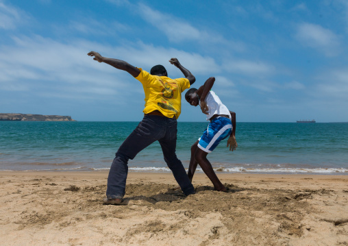 Angolan boys dancing capoeira on the beach, Namibe Province, Namibe, Angola