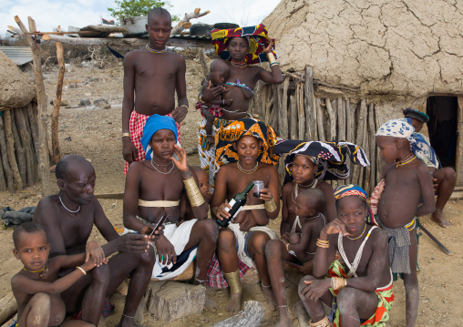 Mucubal tribe people in their village drining wine, Namibe Province, Virei, Angola
