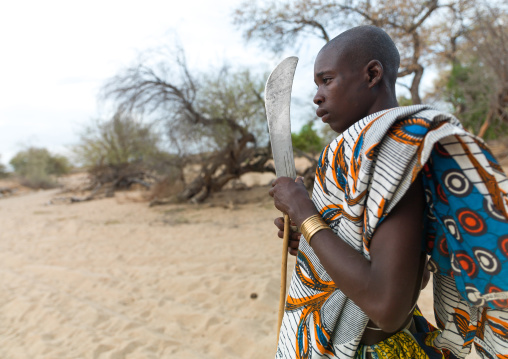 Mucubal tribe man with his machete, Namibe Province, Virei, Angola