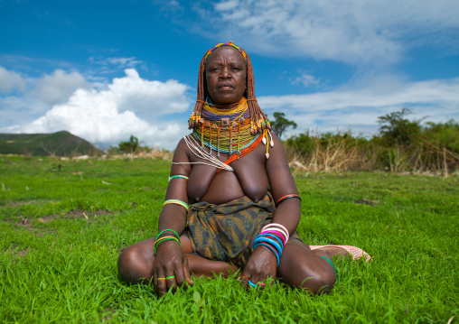 Portrait of a Mumuhuila tribe woman sit in a field, Huila Province, Chibia, Angola