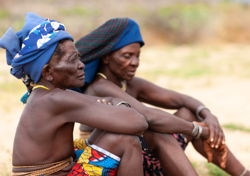 Mucubal tribe women sit, Namibe Province, Virei, Angola