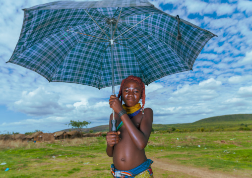 Mumuhuila tribe girl portrait holding an umbrella, Huila Province, Chibia, Angola