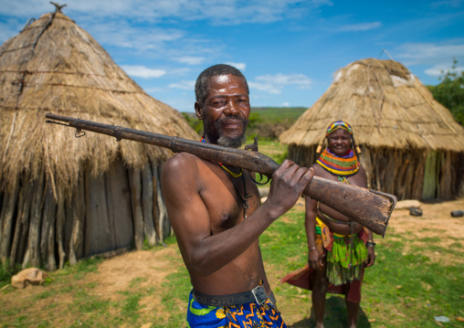 Mumuhuila tribe man with a gun in his village, Huila Province, Chibia, Angola