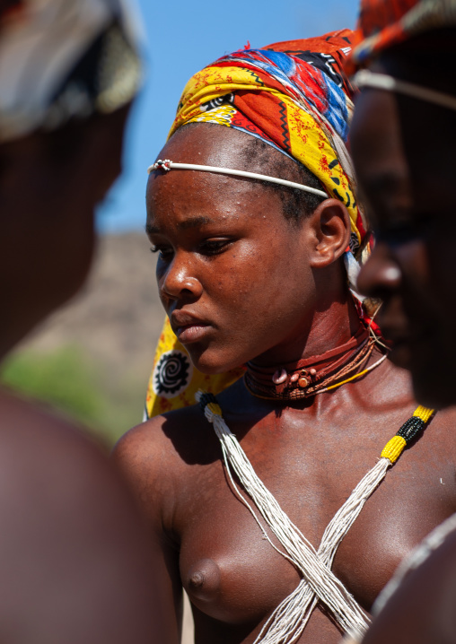 Mucubal tribe young woman wearing a colorful headwear, Namibe Province, Virei, Angola