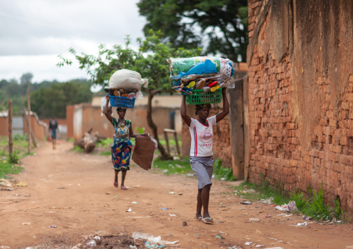 Women walking carrying sacks on head, Huambo Province, Huambo, Angola