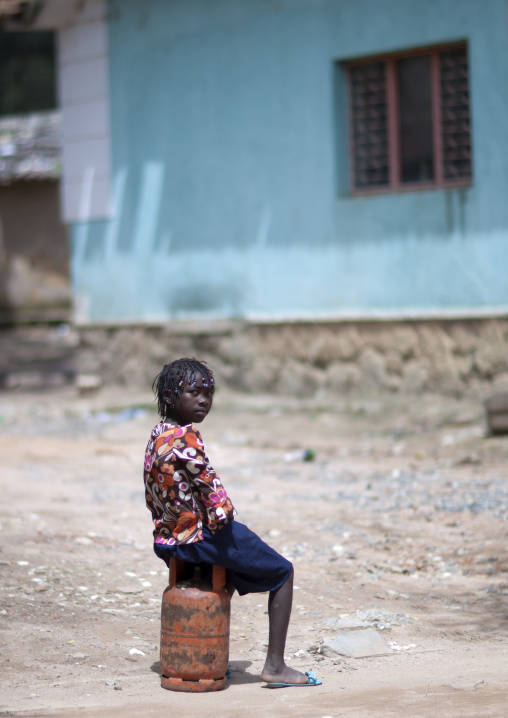 Girl Sitting On A Bottle Of Gas, Huambo, Angola