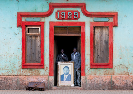 Men Showing Isaías Henrique Ngola Samakuva S Portait At The Entrance Of Unita Headquarters, Chinguar, Angola