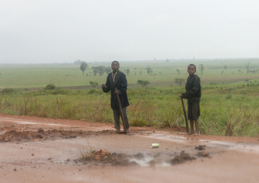 Boys Filling Up Holes Again On The Road, Bie Area, Angola