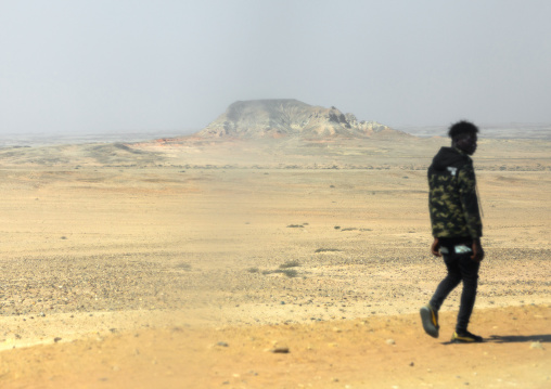 Angolan man walking in the desert, Cunene Province, Curoca, Angola