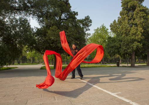 Woman Doing Gymnastic With Ribbons In A Park, Beijing, China