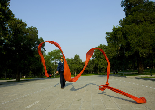 Man Doing Gymnastic With Ribbons In A Park, Beijing, China