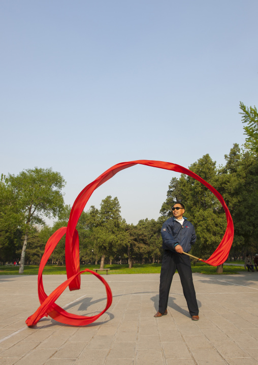 Man Doing Gymnastic With Ribbons In A Park, Beijing, China