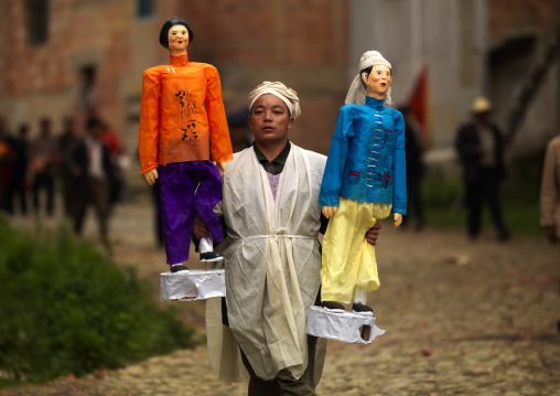 Man Holding Puppets During A Funeral Procession, Yuanyang, Yunnan Province, China