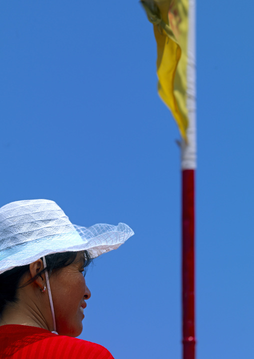 Woman In Front Of A Flag, Xizhou, Yunnan Province, China