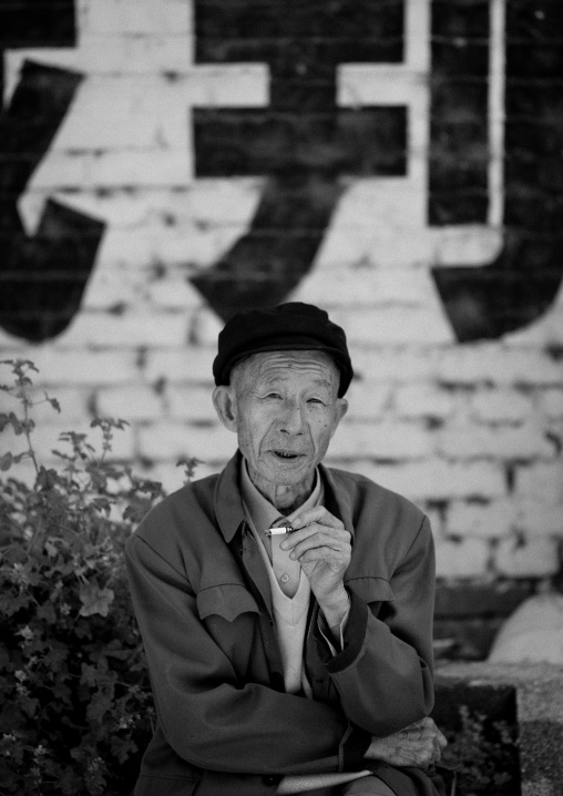 Man Sit In The Street, Xizhou, Yunnan Province, China