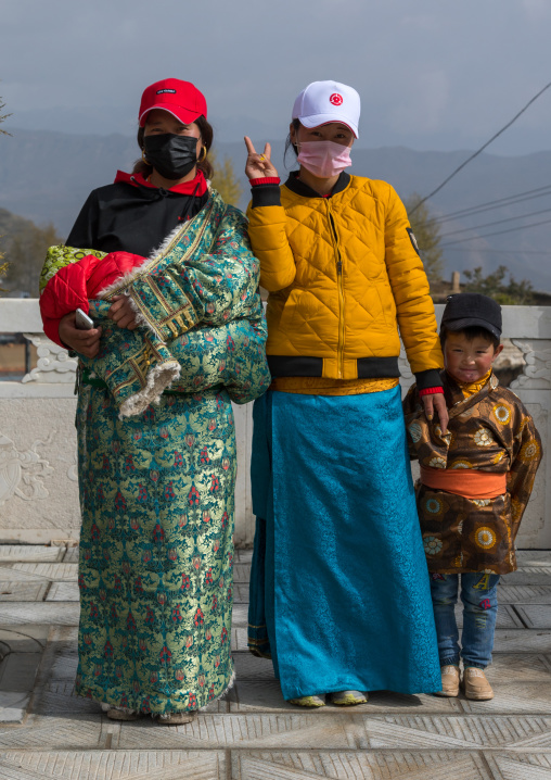 Tibetan pilgrims with traditional and modern clothes in Shachong monastery, Qinghai Province, Wayaotai, China