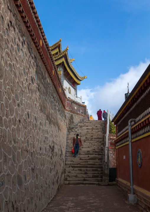 Tibetan pilgrims in the narrow streets of Shachong monastery, Qinghai Province, Wayaotai, China