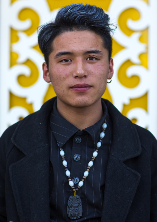 Portrait of young and fashionnable tibetan man, Tongren County, Rebkong, China