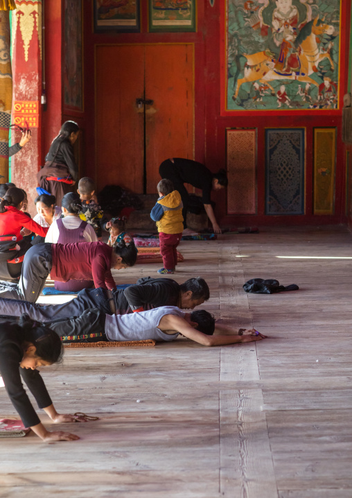 Tibetan pilgrims praying and prostrating in Rongwo monastery, Tongren County, Longwu, China