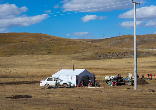Tibetan nomad family living in a tent in the grasslands, Qinghai province, Tsekhog, China