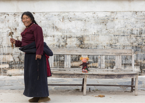 Tibetan nomad woman holding a prayer wheel in her hand, Gansu province, Labrang, China