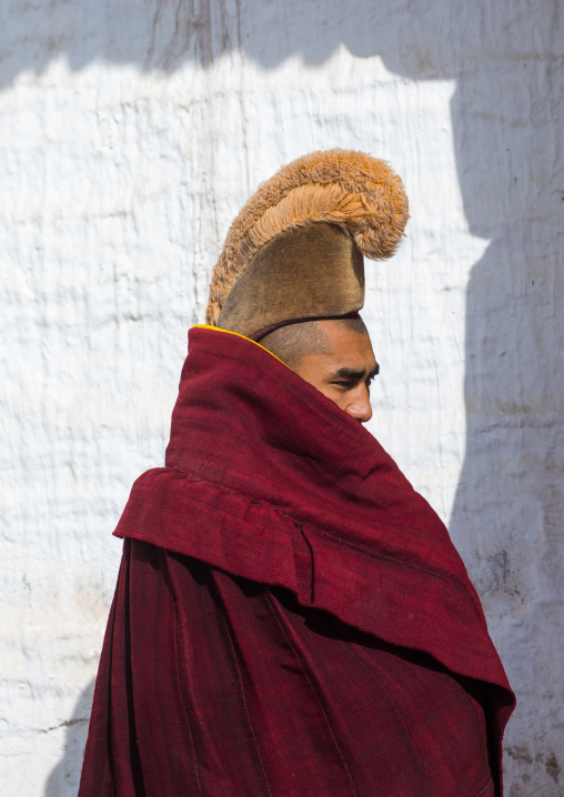 Portrait of a tibetan monk wearing robe and yellow hat of the gelug order or yellow hat sect in Labrang monastery, Gansu province, Labrang, China