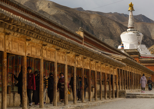 White stupa and prayer wheels in Labrang monastery, Gansu province, Labrang, China