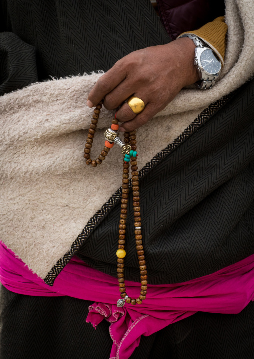 A tibetan pilgrim fingers her prayer beads, Gansu province, Labrang, China